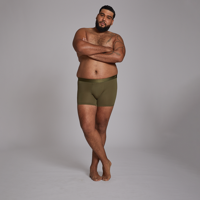 Man in 2XL Green Alphx Boxer-Briefs standing with arms crossed